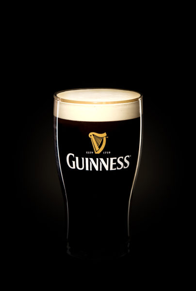 Guinness glass with foamy head