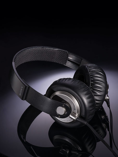 studio photograph of Sony headphones on a reflective black surface