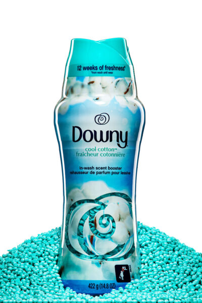 cool cotton Downy Scent Booster bottle sitting in a pile of scent boosters